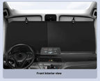 Front interior view of a car with dashboard and steering wheel.
