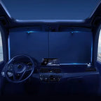 Car interior with illuminated dashboard and steering wheel in a dark setting