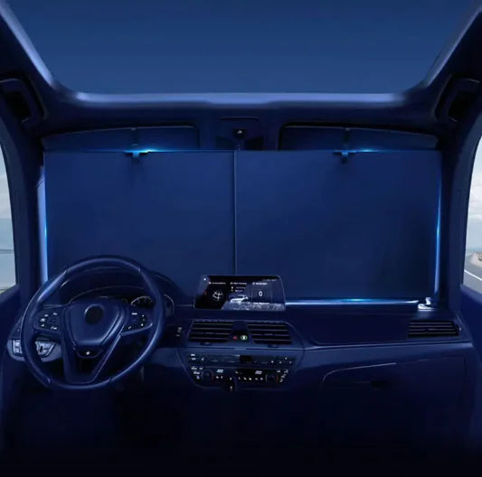 Car interior with illuminated dashboard and steering wheel in a dark setting