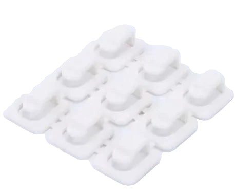 White silicone mold with multiple compartments on a white background